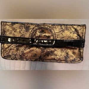 Amici Black and gold negative floral pattern design fold over clutch.